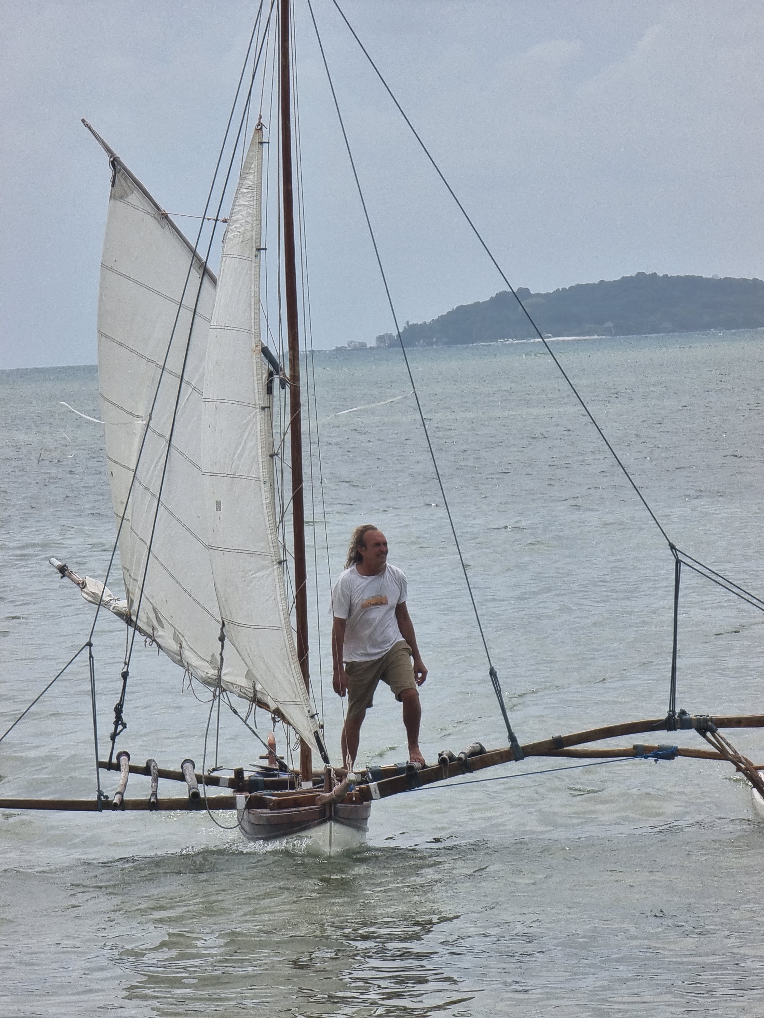 Michel sailing a traditional outrigger off Bintan